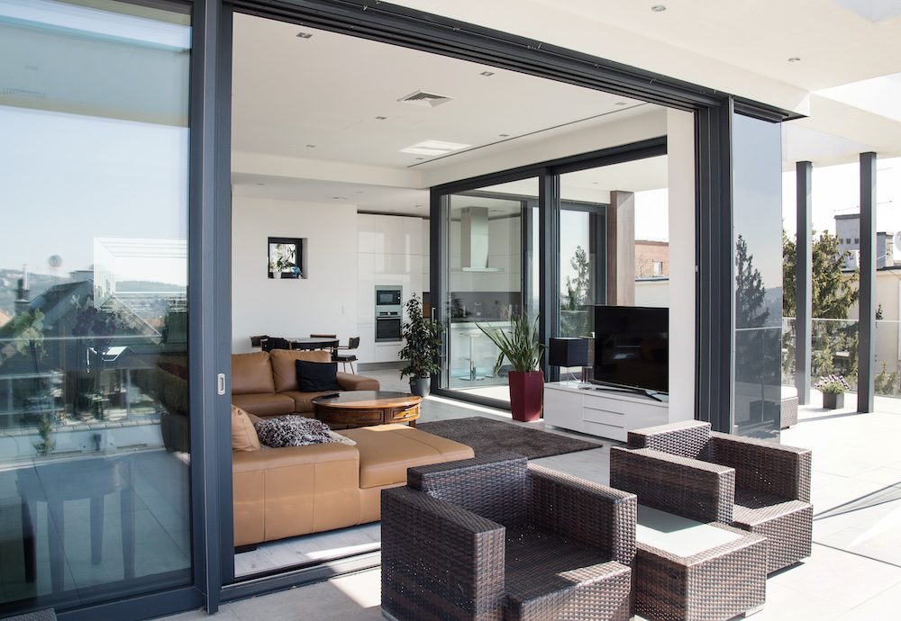 Schuco-aluminium-emelo-tolo-ajto-harom-sines-nyilaszaro-tarsashaz-uveg-homlokzat-burkolat-terasz-minimal-house-uveg-epiteszet-kulter-exterior